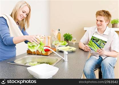 Lunch happy couple cook salad woman wash lettuce