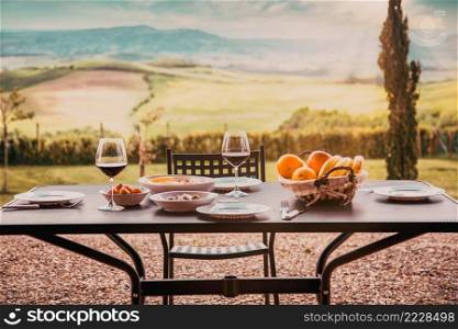 lunch with a view - table against beautiful landscape in Tuscany