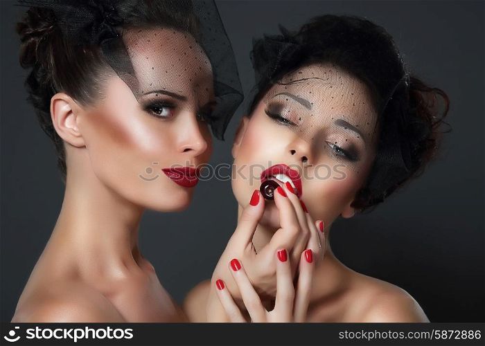 Lure. Two seductive Women with Cherry Berries