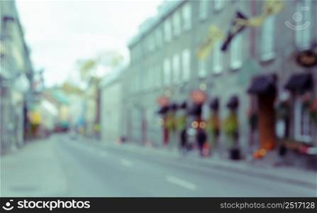 lurred abstract image of old town street with colorful buildings and bokeh lights background
