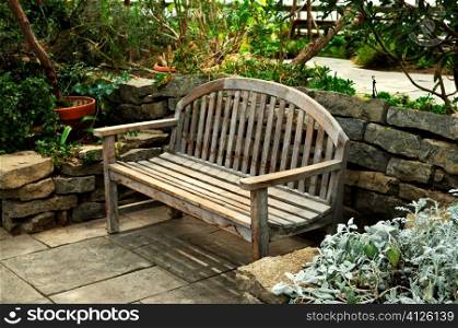 Lush green garden with stone landscaping and bench