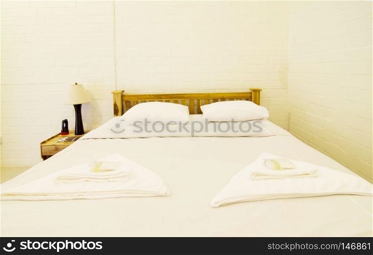 Luxurious bedroom with two towels on the bed