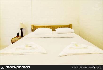 Luxurious bedroom with two towels on the bed