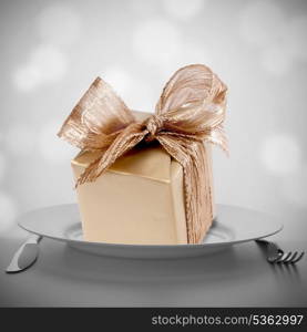 Luxurious gift on plate. Feast concept.