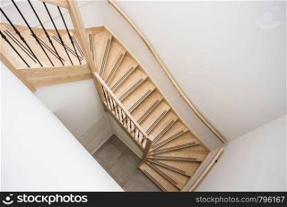 luxurious modern wooden staircase with curved landing wall modern design. luxurious modern wooden staircase with curved landing wall in a house