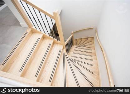 luxurious modern wooden staircase with curved landing wall modern design. luxurious modern wooden staircase with curved landing wall in a house