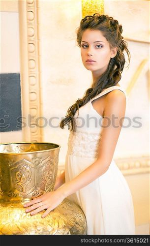 Luxurious Posh Brunette in White Dress. Oriental Antique Golden Decor