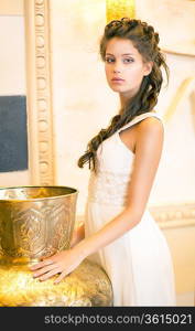 Luxurious Posh Brunette in White Dress. Oriental Antique Golden Decor