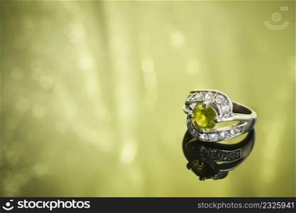 luxurious ring on green reflective surface