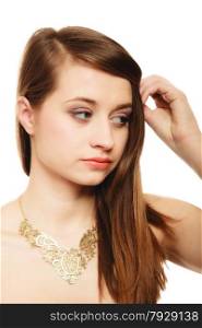 Luxury accessories. Face of young woman. Portrait of girl in golden necklace isolated on white.