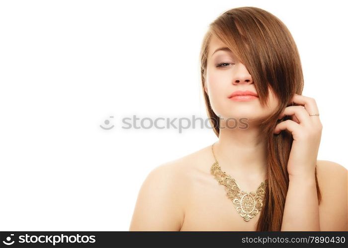Luxury accessories. Face of young woman with bang covering her eye. Portrait of girl in golden necklace isolated on white.