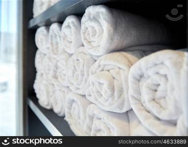 luxury and hygiene concept - rolled white bath towels at hotel spa. rolled white bath towels at hotel spa