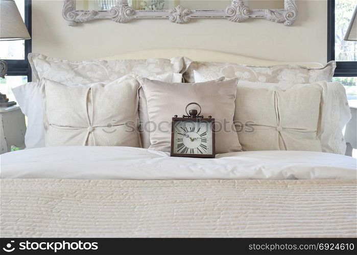 luxury bedroom interior with classic style alarm clock on bed
