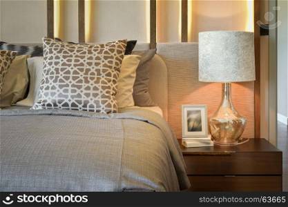 luxury bedroom with white lamp with picture frame on wooden table