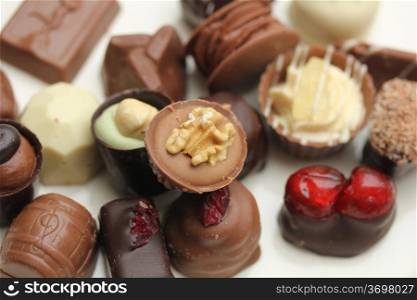 Luxury belgium chocolate pralines, decorated with fruits and nuts