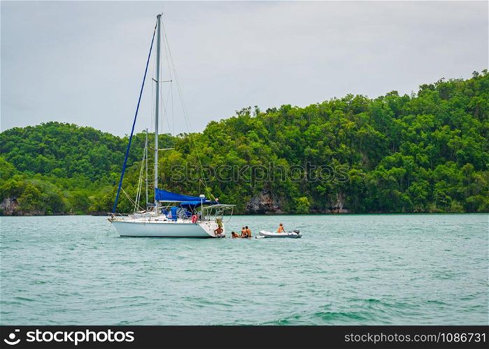 Luxury boat anchored close to exotic tropical island. Panoramic landscape view of Los Haitises natural park,Samana peninsula in Dominican republic.