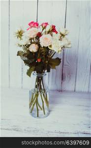 Luxury bouquet of roses lying over wooden wall. Copy space. Bouquet of roses