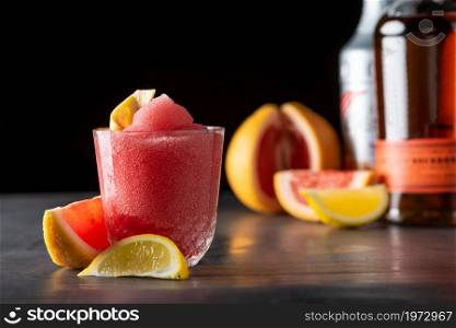 Luxury cocktail and cocktail shaker on black stone background