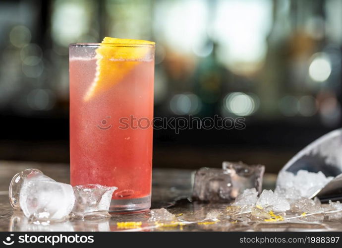 Luxury cocktail and cocktail shaker on black stone background