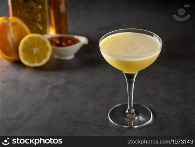 Luxury cocktail with lemon and tequila on a dark stone background