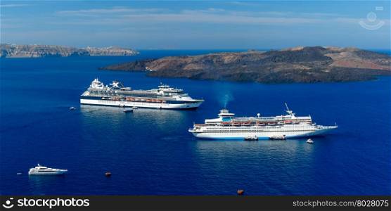 Luxury cruise ships, caldera and volcano near Fira, modern capital of the Greek Aegean island, Santorini, Greece. Panorama