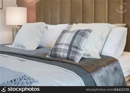 Luxury decorative style bedroom with checked pattern pillows on bed