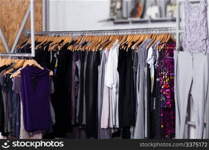 Luxury fashion clothes in display for sale in a retail shop