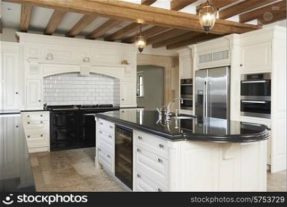 Luxury Fitted Kitchen In House With Beamed Ceiling