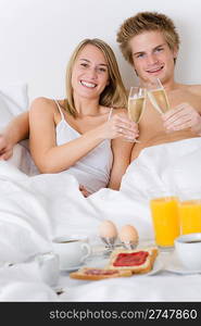 Luxury hotel honeymoon breakfast - couple in white bed together