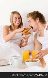 Luxury hotel honeymoon breakfast - couple in white bed together