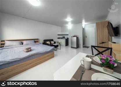Luxury Interior living room with sofa bed and bed queen size, Dining table,air conditioner, and furniture, Studio room type of condominium or apartment, service apartment and Accommodations Concept