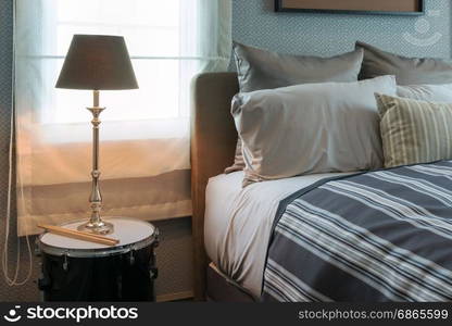 luxury lamp on bedside table in stylish bedroom interior