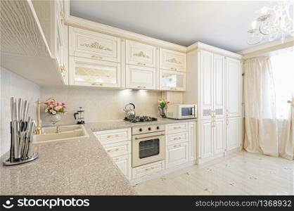 Luxury modern beige and cream colored kitchen in modern classic style.. Luxury modern beige and cream colored kitchen interior
