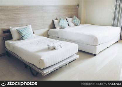 Luxury modern classic bedroom with white bed sheet and white green pillow comfortable residential hotel style. Clean bedroom with fabric curtain textile.