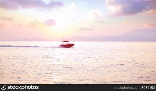 Luxury motorboat on the sea in mild pink sunset light, active lifestyle, expensive water transport, summer vacation, speed and freedom concept