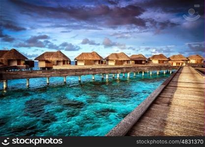 Luxury resort, many cute bungalow on the water, amazing view, beautiful coral under transparent water, summer holidays concept
