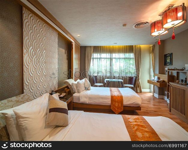 Luxury room with bed with vintage decoration, Chinese style, room of hotel resort in Thailand.
