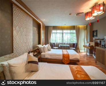 Luxury room with bed with vintage decoration, Chinese style, room of hotel resort in Thailand.