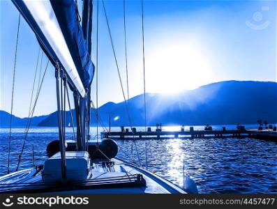 Luxury sail boat on the sea, sun down, beautiful seascape, summer vacation, yachting sport, traveling on water transport