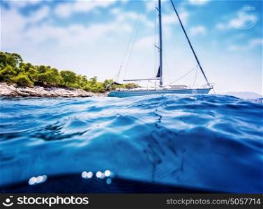 Luxury sailboat anchored near tropical island, amazing cruise along Greece, unforgettable summertime adventure, travel and tourism concept