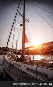 Luxury sailboat in sunset, old harbor in beautiful Europe city, water transport, sea cruise, summer vacation, travel and tourism concept