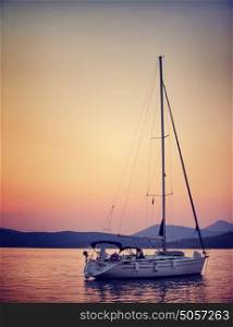 Luxury sailboat in the sea in beautiful sunset light, interesting summer adventure, romantic date on the water, travel and tourism concept