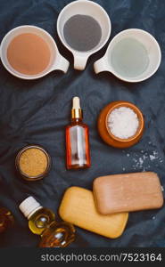luxury Set of spa products with different kind of clay on black background. flat lay