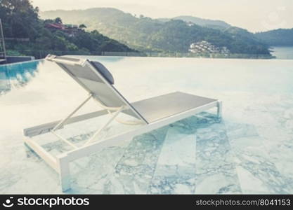 Luxury swimming pool and blue water at the resort with beautiful sea view (Vintage filter effect used)