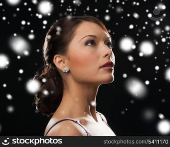 luxury, vip, nightlife, party, christmas, x-mas, new year&#39;s eve concept - beautiful woman in evening dress wearing diamond earrings