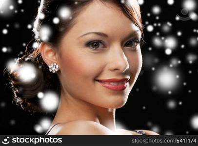 luxury, vip, nightlife, party, christmas, x-mas, new year&#39;s eve concept - beautiful woman in evening dress wearing diamond earrings