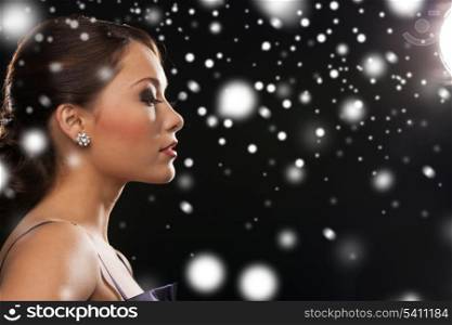 luxury, vip, nightlife, party, christmas, x-mas, new year&#39;s eve concept - beautiful woman in evening dress wearing diamond earrings