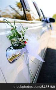Luxury wedding car decorated with flowers, selective focus.