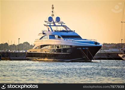 Luxury yacht in harbor on golen sunset