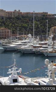 Luxury yachts moored in the harbor in the Principality of Monaco on the French Riviera in the South of France.